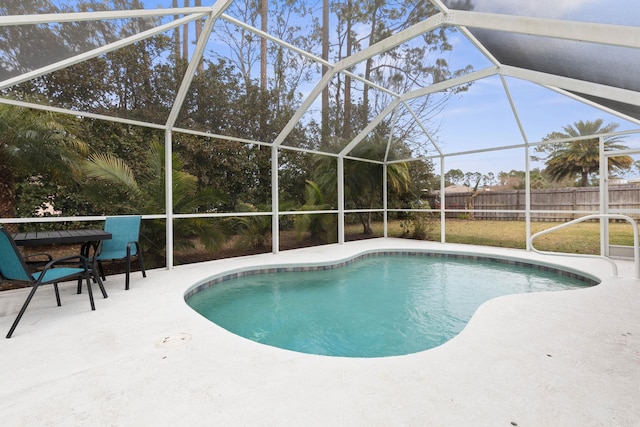 view of swimming pool featuring a lanai and a patio area