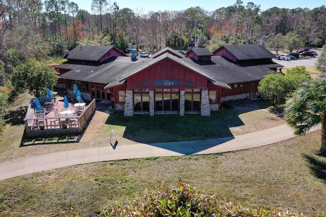 rear view of house featuring a lawn