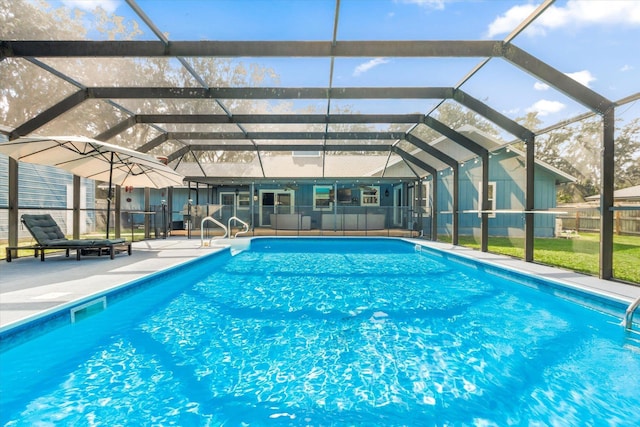 view of pool featuring glass enclosure and a patio