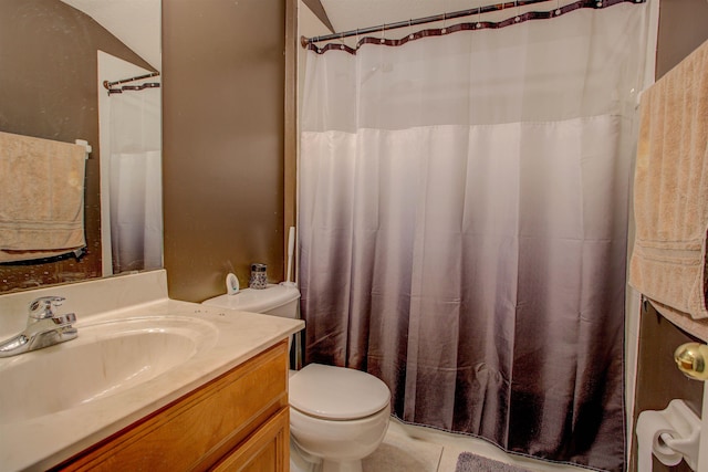 bathroom with tile patterned flooring, vanity, and toilet