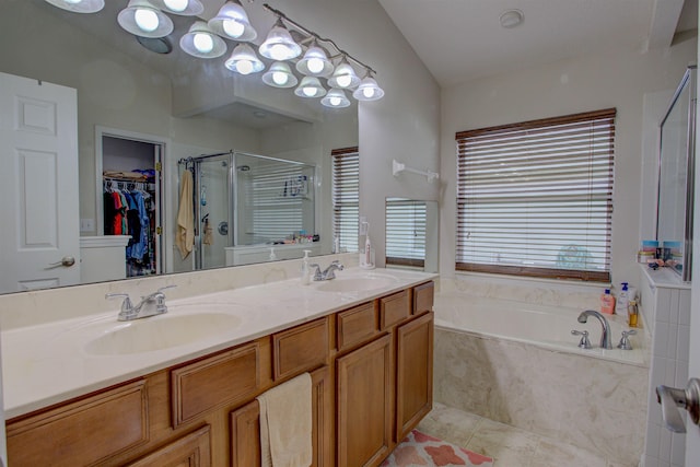 bathroom featuring tile patterned floors, vanity, plus walk in shower, and lofted ceiling