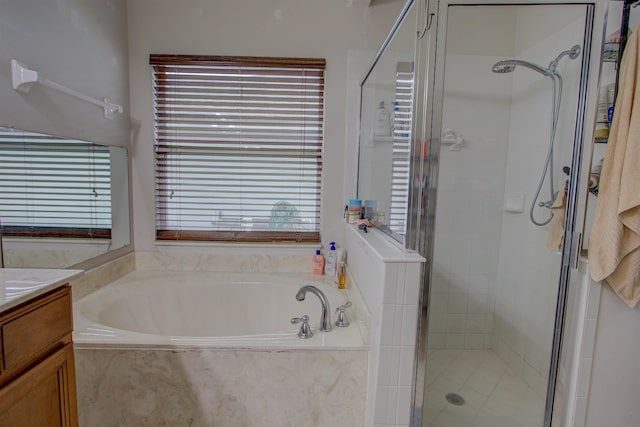 bathroom with shower with separate bathtub and vanity