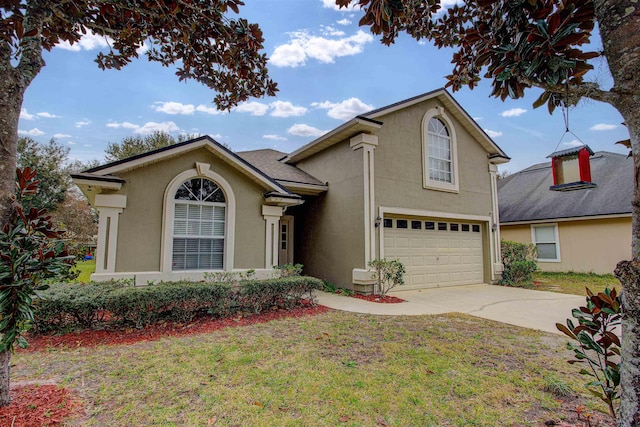 view of property featuring a front lawn and a garage