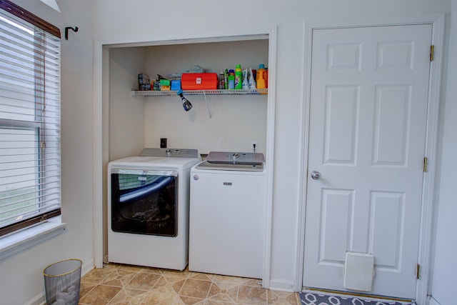 washroom with light tile patterned flooring and washer and dryer