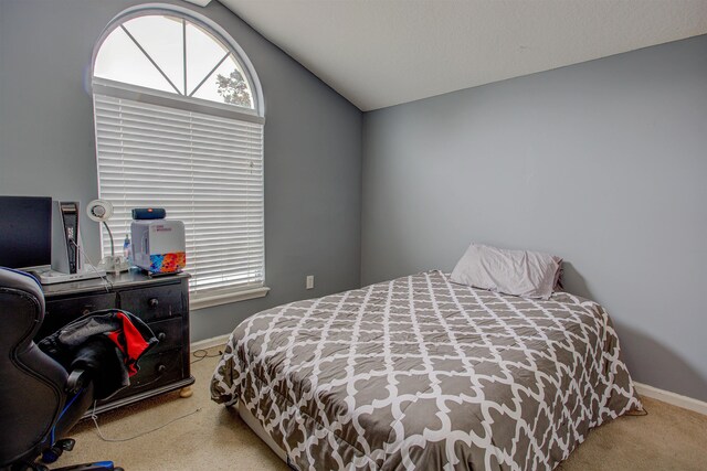 carpeted bedroom with vaulted ceiling