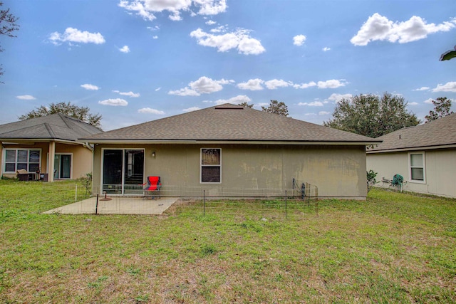 rear view of house with a lawn and a patio area