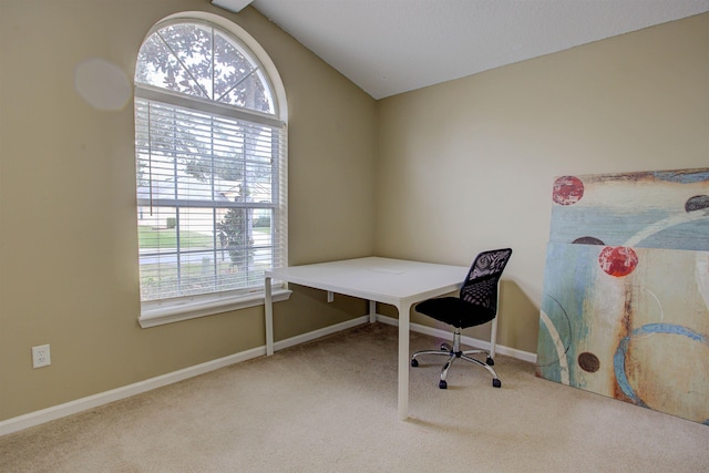 carpeted office space with vaulted ceiling