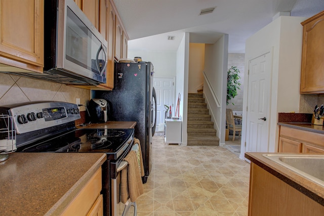 kitchen with black range with electric stovetop and backsplash