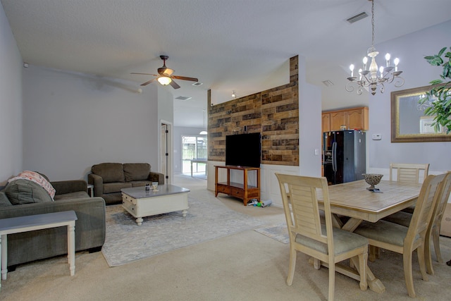 carpeted dining area featuring ceiling fan with notable chandelier and lofted ceiling