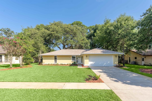 ranch-style home featuring a garage, central air condition unit, and a front lawn