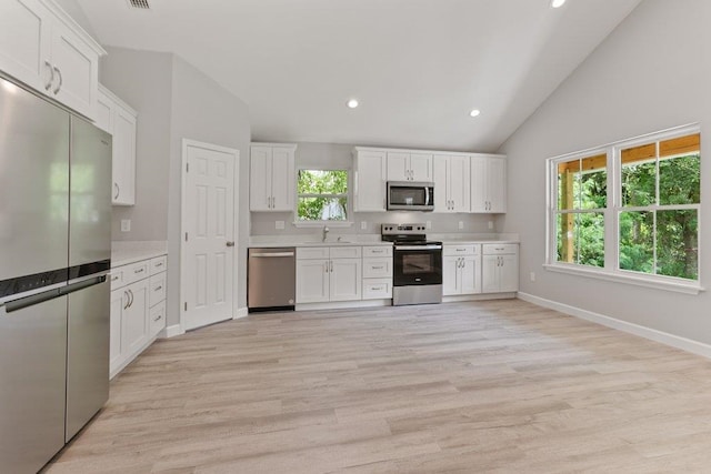 2891 N 8th St, Saint Augustine, FL 32084 - kitchen featuring appliances with stainless steel finishes, light countertops, white cabinets, light wood-style flooring, and recessed lighting