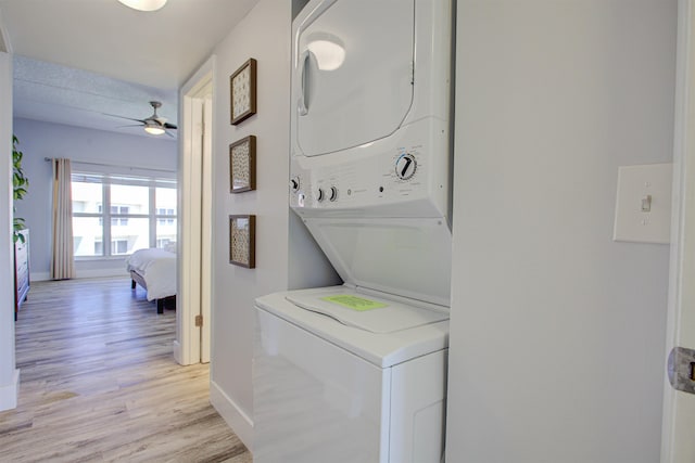 390 A1A Beach Blvd Unit 43, Saint Augustine Beach, FL 32080 - washroom featuring stacked washer and clothes dryer, light wood-type flooring, baseboards, and a ceiling fan