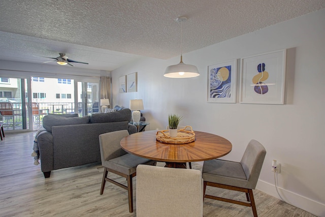 390 A1A Beach Blvd Unit 43, Saint Augustine Beach, FL 32080 - dining space with a textured ceiling, light wood-style floors, baseboards, and ceiling fan