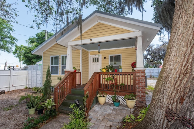 rear view of property with covered porch