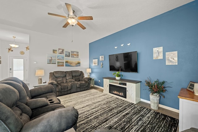 living room featuring hardwood / wood-style flooring, a high end fireplace, and ceiling fan