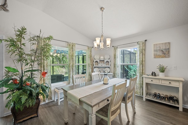 dining space featuring lofted ceiling, dark hardwood / wood-style floors, a notable chandelier, and a textured ceiling