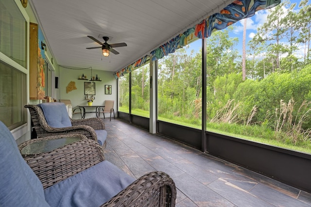 sunroom featuring ceiling fan