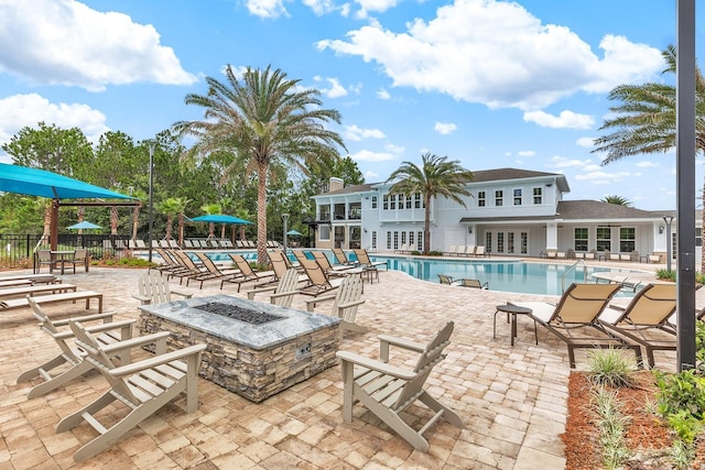 view of swimming pool featuring a fire pit, a patio, and french doors