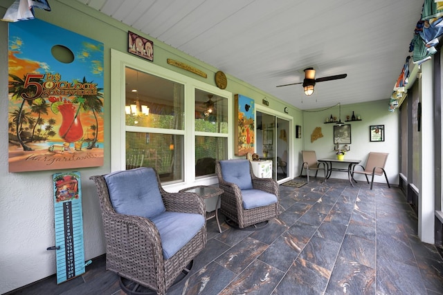 sunroom featuring ceiling fan