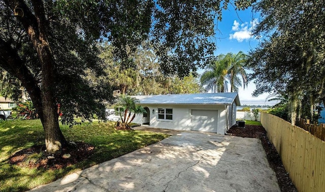 view of front of house featuring a front yard, a garage, and central air condition unit