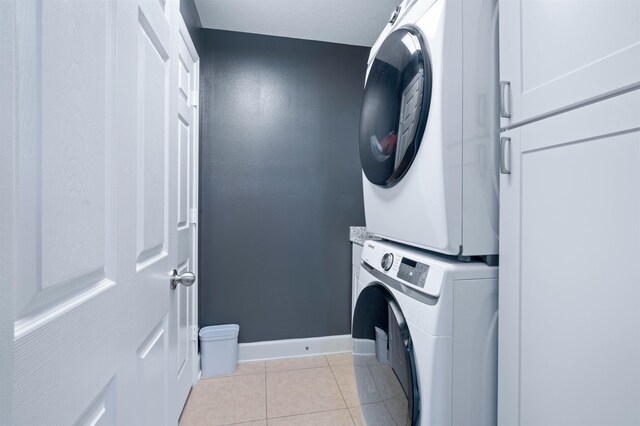 201 N Saxxon Rd, Saint Augustine, FL 32092 - laundry room with baseboards, laundry area, stacked washer / drying machine, and light tile patterned flooring