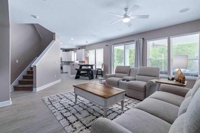 201 N Saxxon Rd, Saint Augustine, FL 32092 - living area featuring baseboards, plenty of natural light, stairway, and ceiling fan