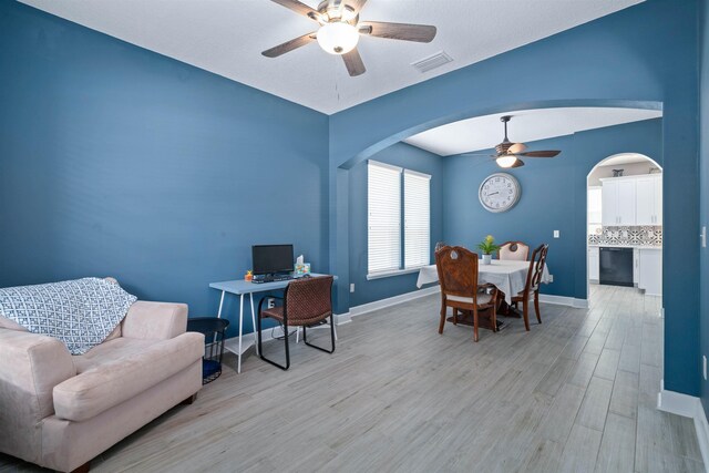 201 N Saxxon Rd, Saint Augustine, FL 32092 - home office featuring ceiling fan, arched walkways, light wood-style flooring, baseboards, and visible vents