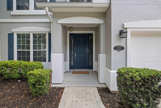 201 N Saxxon Rd, Saint Augustine, FL 32092 - property entrance with a garage and stucco siding