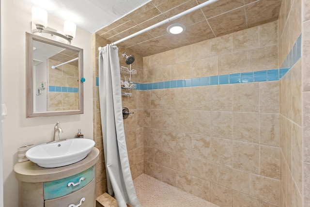 bathroom featuring a shower stall and vanity