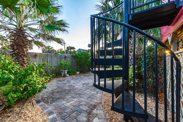 exterior space with a fenced backyard and stairway