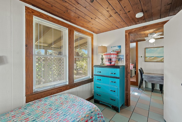 bedroom featuring wooden ceiling, light tile patterned flooring, and wooden walls