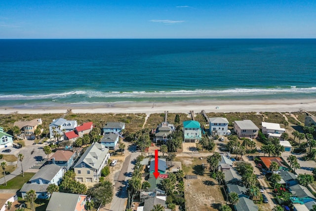 bird's eye view with a residential view, a water view, and a beach view