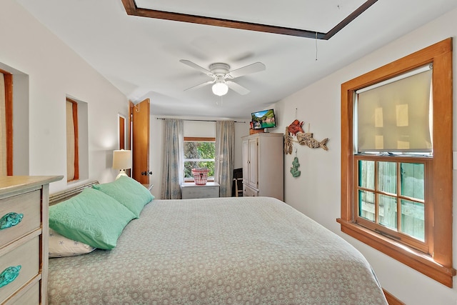 bedroom with attic access and a ceiling fan