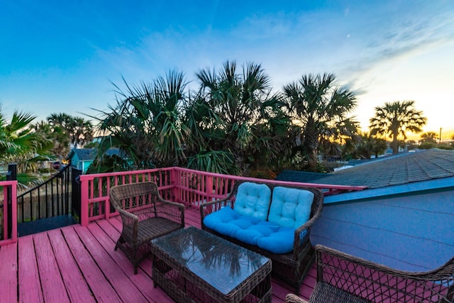 deck at dusk featuring an outdoor hangout area