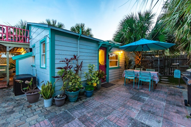 exterior space with outdoor dining area and fence