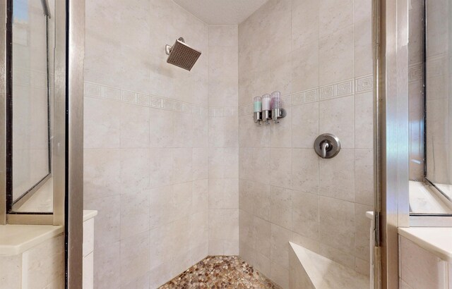 full bath featuring a tile shower