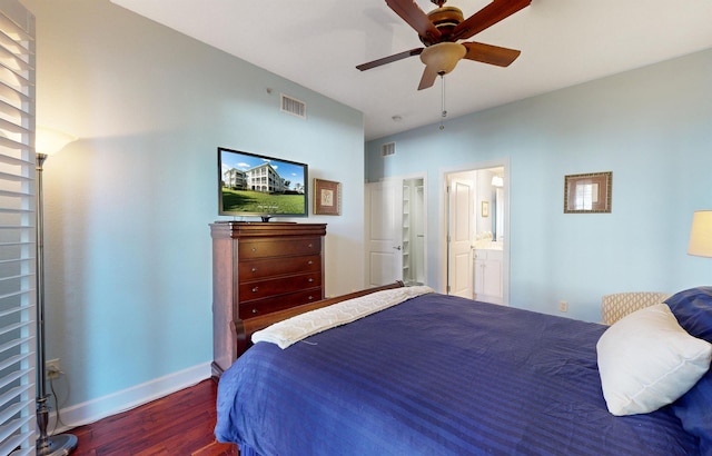 bedroom with ensuite bath, baseboards, visible vents, and dark wood-style flooring