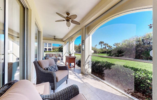 sunroom featuring ceiling fan