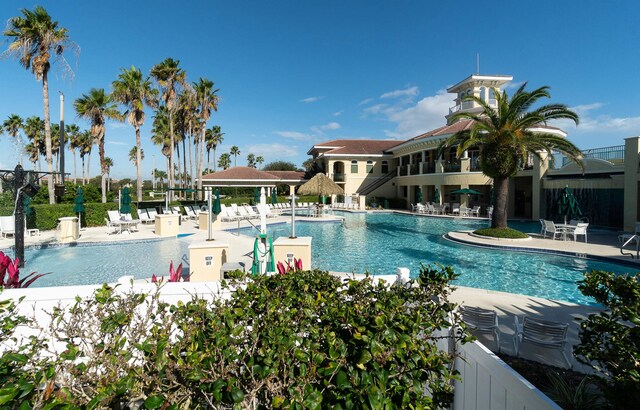 pool with a patio area and fence