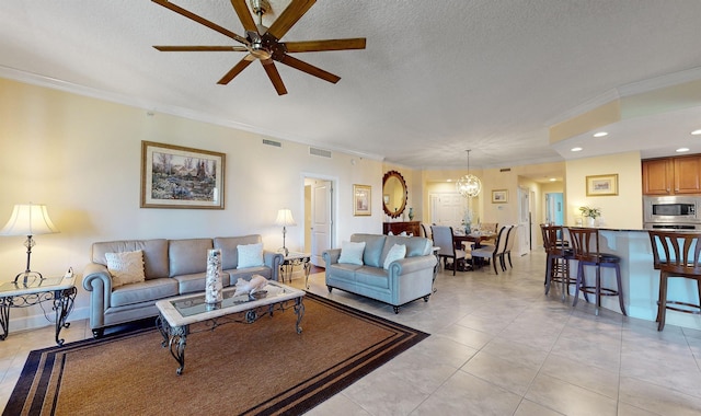 living room with crown molding, light tile patterned floors, and ceiling fan with notable chandelier