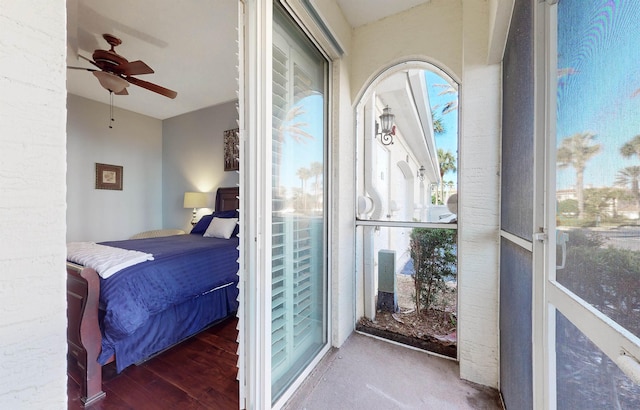 bedroom with wood finished floors, a ceiling fan, and access to exterior