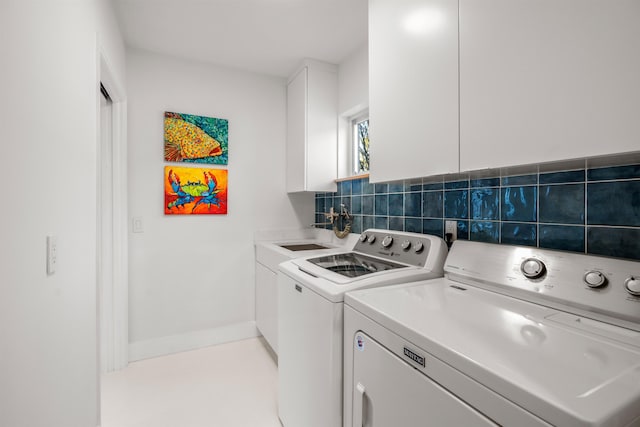 101 Dolphin Dr, Saint Augustine, FL 32080 - laundry area featuring baseboards, cabinet space, and washer and dryer