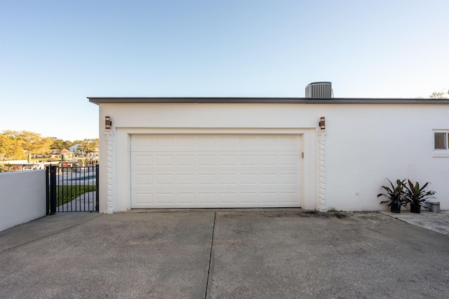 101 Dolphin Dr, Saint Augustine, FL 32080 - garage with a gate, fence, and central AC