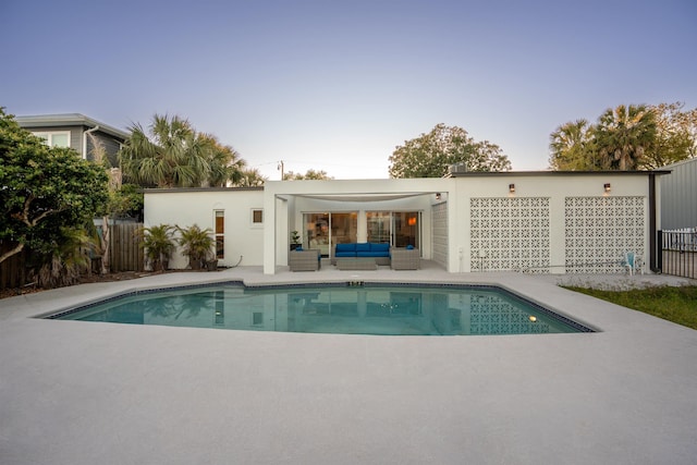 101 Dolphin Dr, Saint Augustine, FL 32080 - back of house featuring stucco siding, fence, an outdoor living space, a fenced in pool, and a patio area