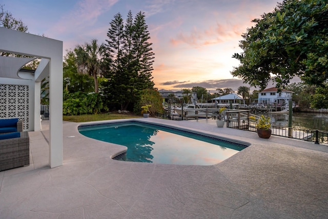 101 Dolphin Dr, Saint Augustine, FL 32080 - pool at dusk featuring an outdoor pool, a dock, and a patio area