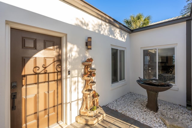 101 Dolphin Dr, Saint Augustine, FL 32080 - doorway to property featuring stucco siding