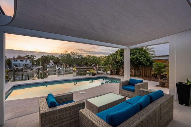 101 Dolphin Dr, Saint Augustine, FL 32080 - pool at dusk with an outdoor hangout area, fence, a patio, a fenced in pool, and a boat dock