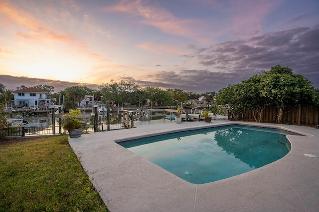 101 Dolphin Dr, Saint Augustine, FL 32080 - pool at dusk with a fenced in pool, a dock, fence, and a patio