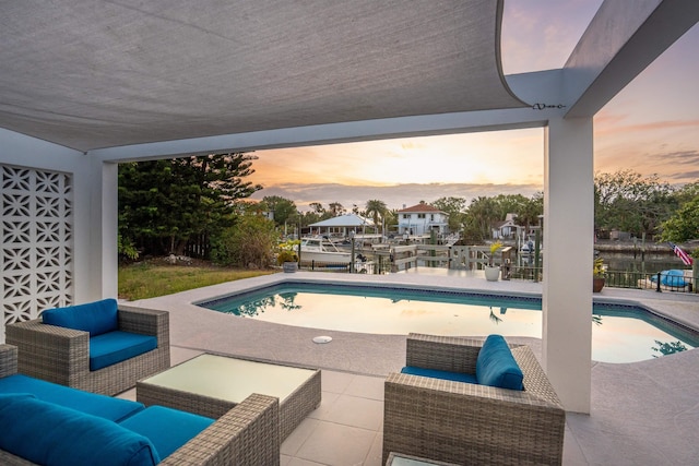 101 Dolphin Dr, Saint Augustine, FL 32080 - pool at dusk with an outdoor living space, an outdoor pool, and a patio area