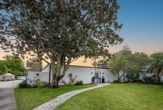 101 Dolphin Dr, Saint Augustine, FL 32080 - view of front of property with a gate, stucco siding, fence, and a front lawn